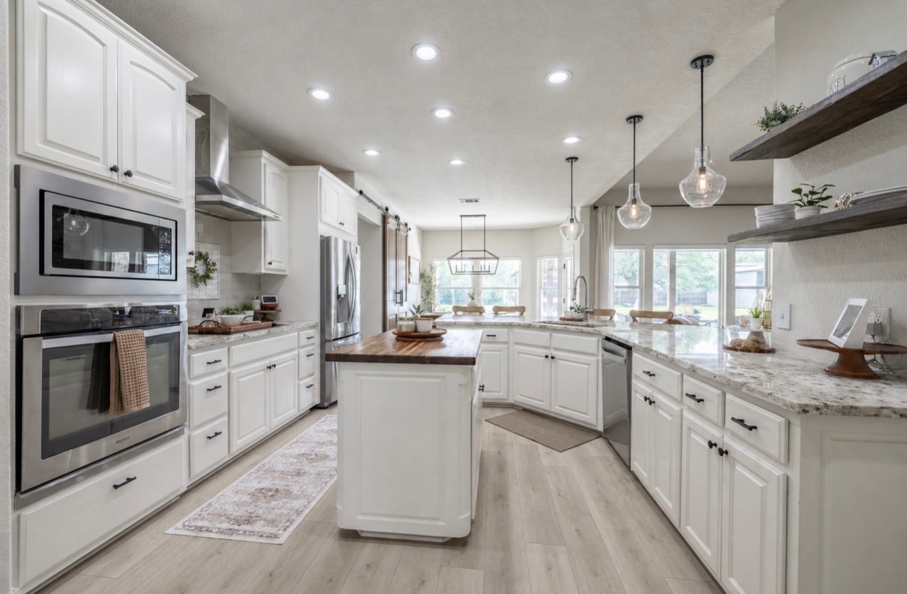 108 Kyle Lane Georgetown, TX 78633 - Photo 6 of 26 Spacious kitchen featuring white cabinetry, light wood-finish flooring, recessed lighting, and stainless steel appliances including a built-in microwave and oven
