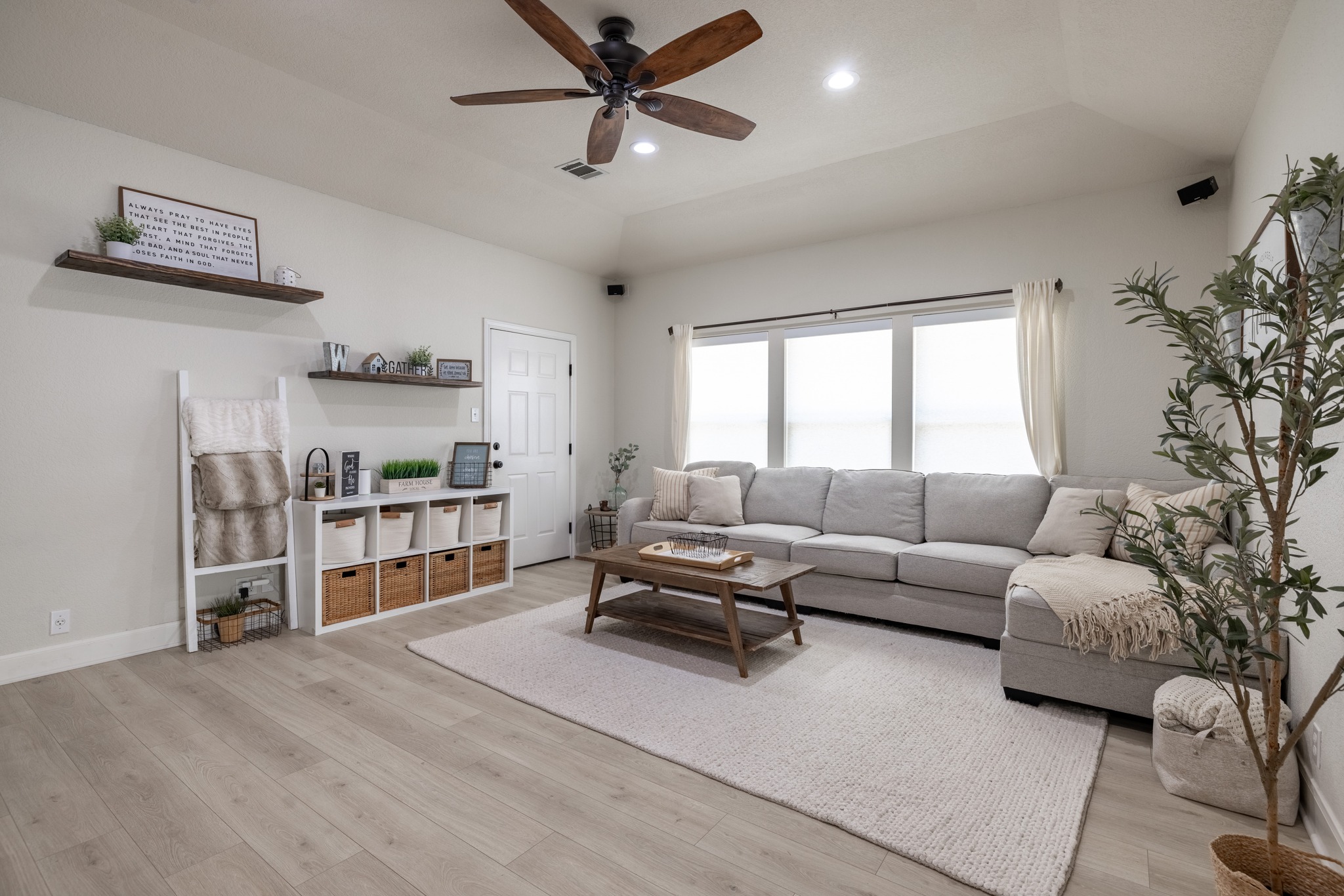 108 Kyle Lane Georgetown, TX 78633 - Photo 8 of 26 Living area featuring light wood-finish flooring, a ceiling fan with integrated lighting, recessed ceiling lights, and multiple windows with blinds