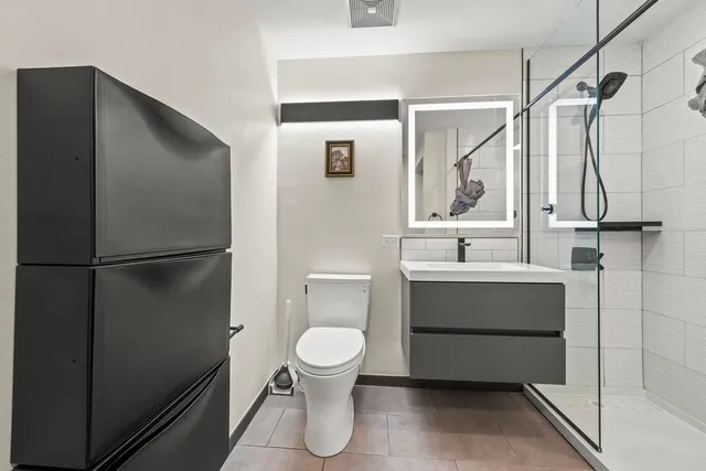 a bathroom with a toilet sink and shower