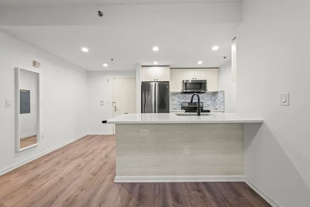 a view of kitchen with wooden floor