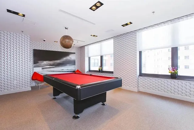 a room with pool table and window