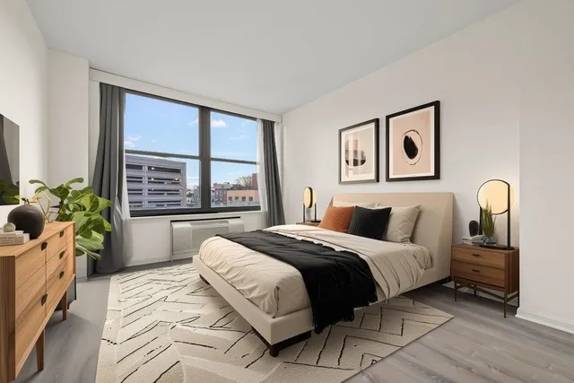 a bedroom with a large bed and a large window