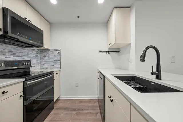a kitchen with a sink and stainless steel appliances