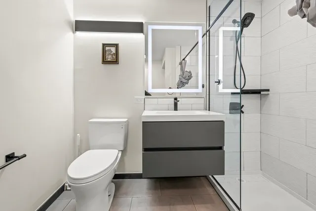 a bathroom with a sink toilet and shower