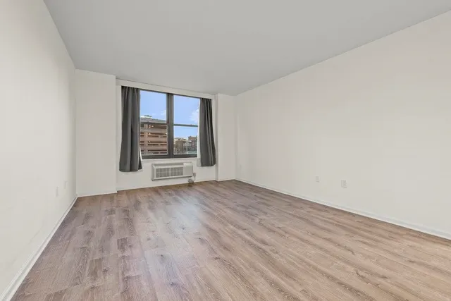 wooden floor in an empty room with a window