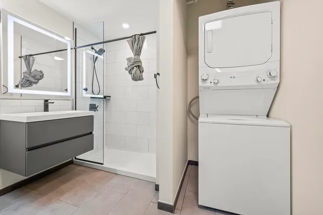 a bathroom with a sink a mirror and a shower