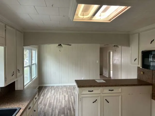 a view of a kitchen counter space with wooden floor
