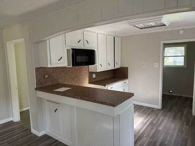 a kitchen with stainless steel appliances granite countertop a sink a microwave counter space and cabinets