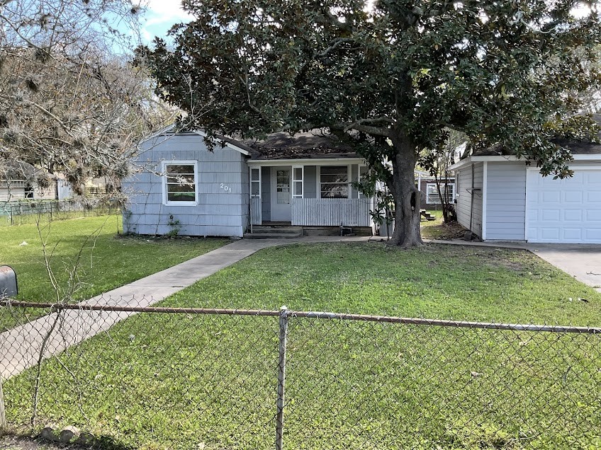 201 Smith Street Clute, TX 77531 - Photo 2 of 22 a house view with a garden space