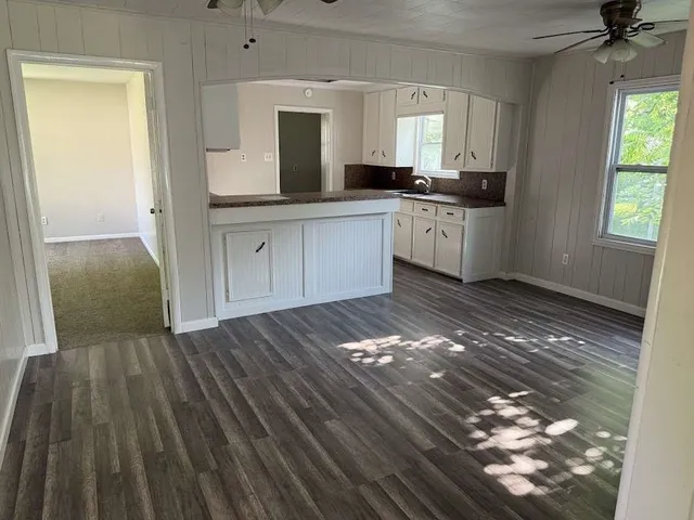 a kitchen with granite countertop a sink and cabinets