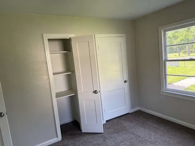 a view of an empty room with a window