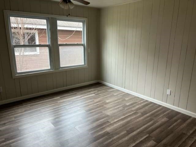 201 Smith Street Clute, TX 77531 - Photo 8 of 22 an empty room with wooden floor and windows
