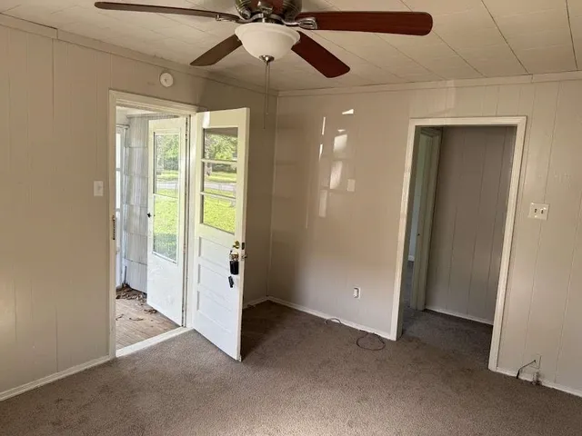 a view of an empty room with a ceiling fan