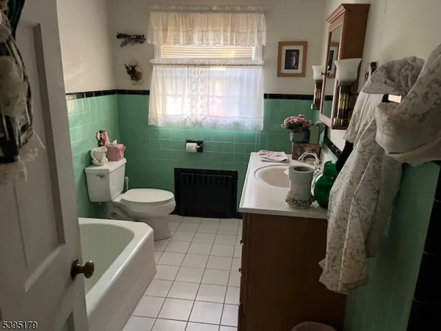 a bathroom with a sink toilet and window
