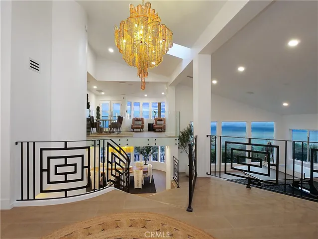 a view of a room with furniture and chandelier