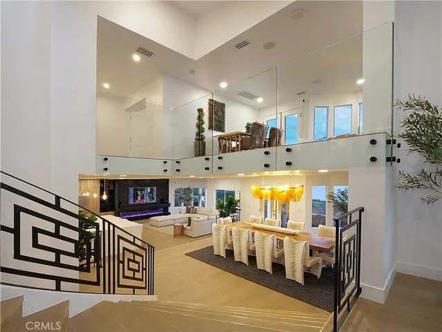 a kitchen with stainless steel appliances kitchen island granite countertop a refrigerator a stove and a oven with wooden floor