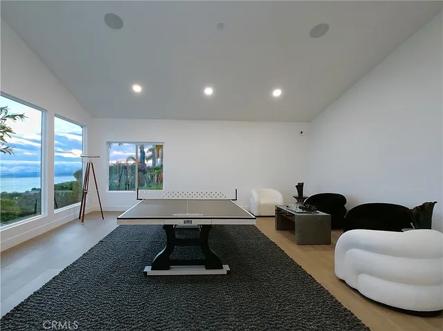 a living room with furniture rug and large windows