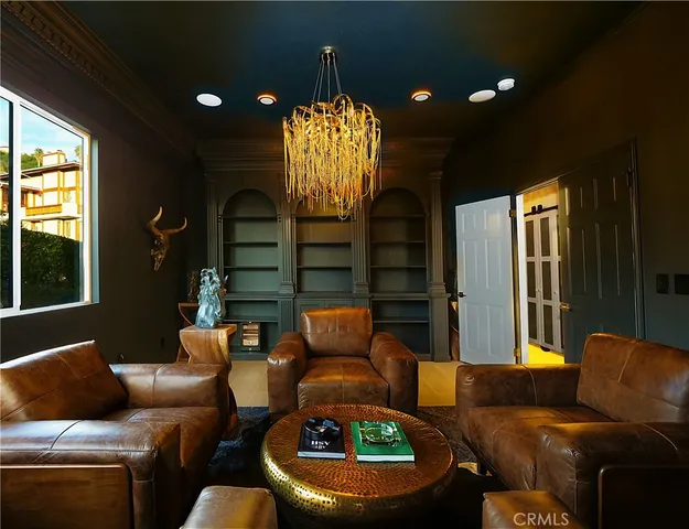 a living room with furniture and a chandelier