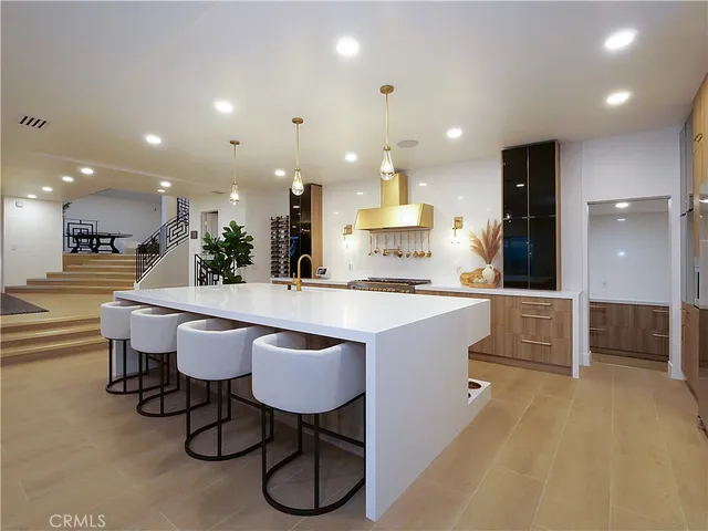 a large kitchen with a table and chairs