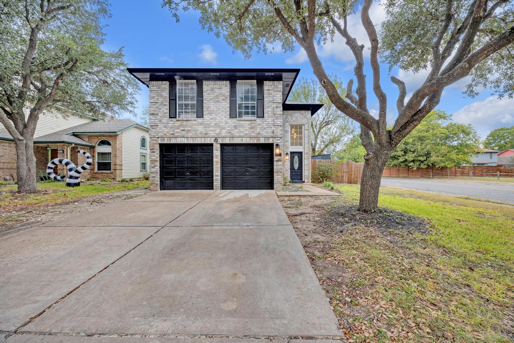 a front view of a house with a yard and garage