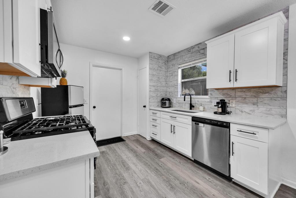 600 Smoke Signal Pass Pflugerville, TX 78660 - Photo 12 of 35 a kitchen with cabinets stove and a sink