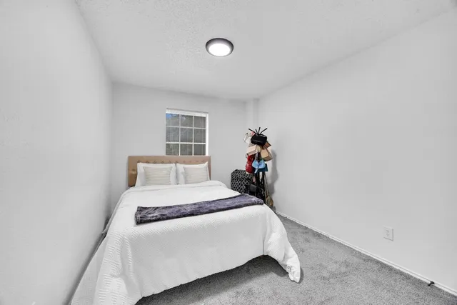 a bed room with a bed and a window