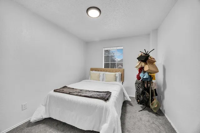 a bed room with a bed and a potted plant