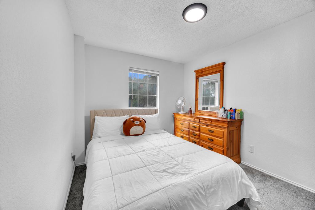 600 Smoke Signal Pass Pflugerville, TX 78660 - Photo 19 of 35 a bedroom with a bed and wooden floor