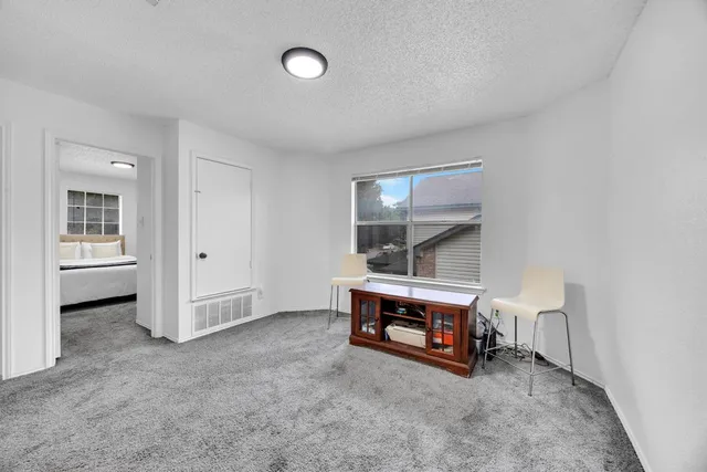 an empty room with furniture and window