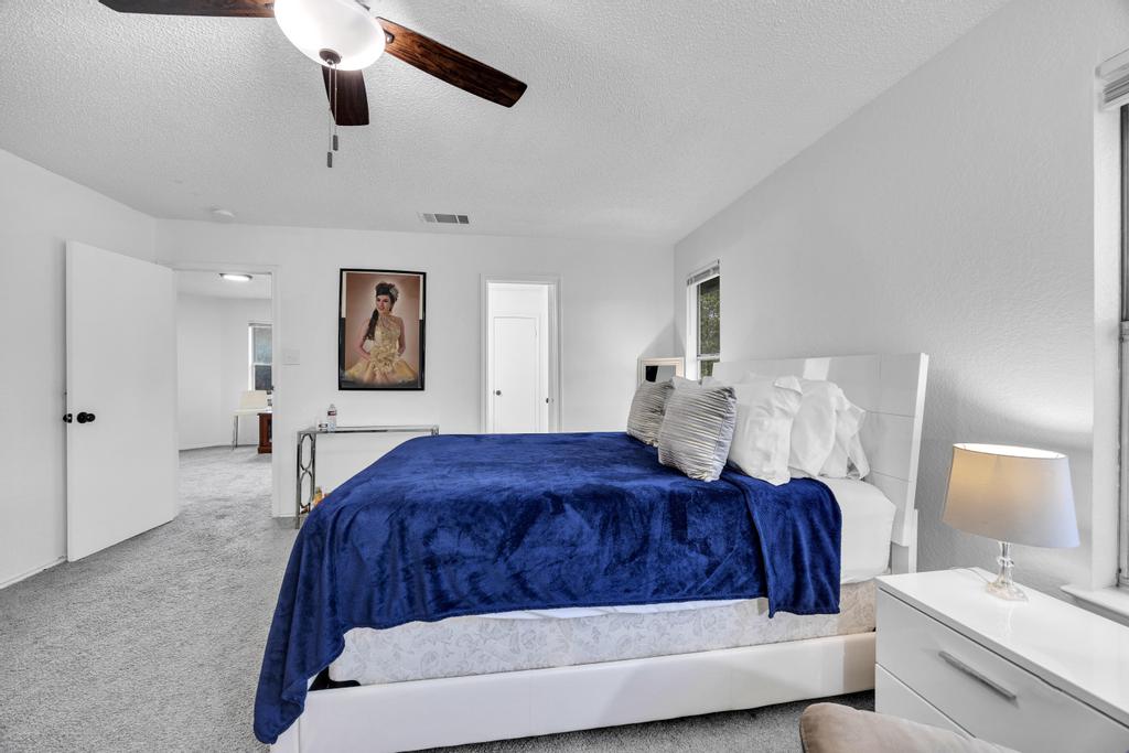 600 Smoke Signal Pass Pflugerville, TX 78660 - Photo 25 of 35 a bedroom with a large bed and bathroom