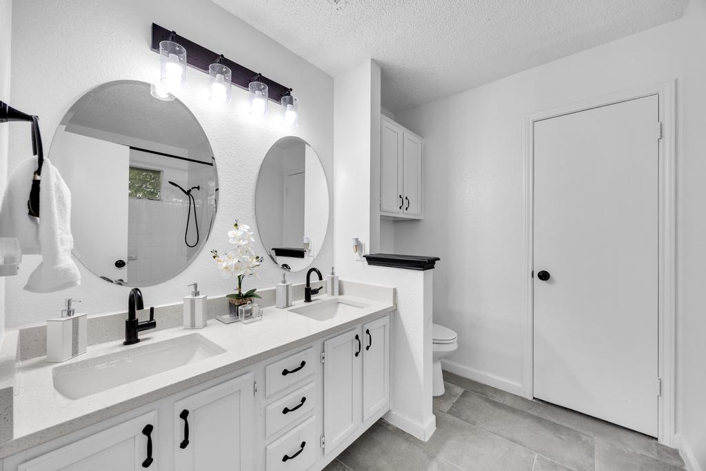 600 Smoke Signal Pass Pflugerville, TX 78660 - Photo 26 of 35 a bathroom with a double vanity sink and mirror with toilet