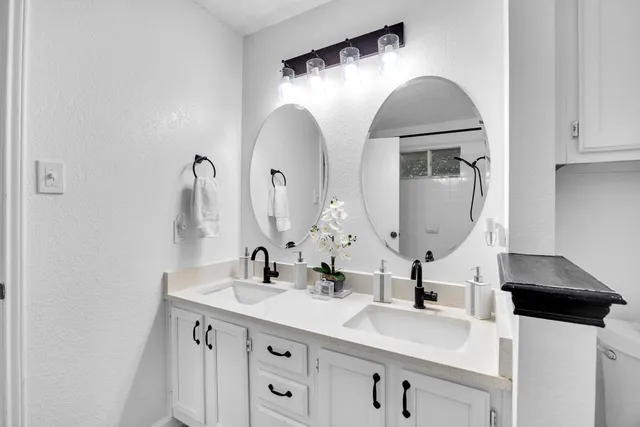 a bathroom with a double vanity sink and a mirror