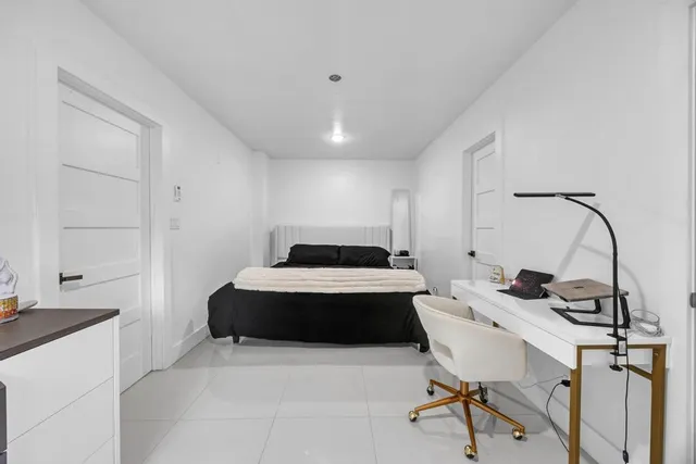 a bedroom with a bed and a desk