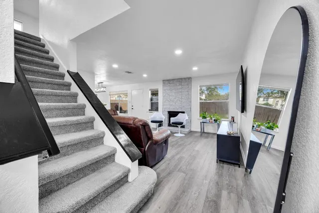 a living room with furniture and wooden floor