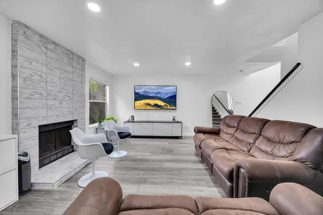 a living room with furniture and a fireplace