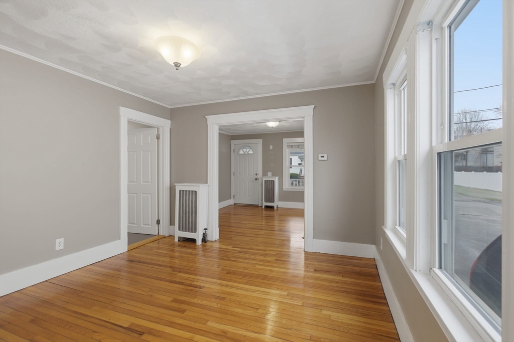 12 Riverside Court Saugus, MA 01906 - Photo 12 of 39 a view of empty room with wooden floor and fan