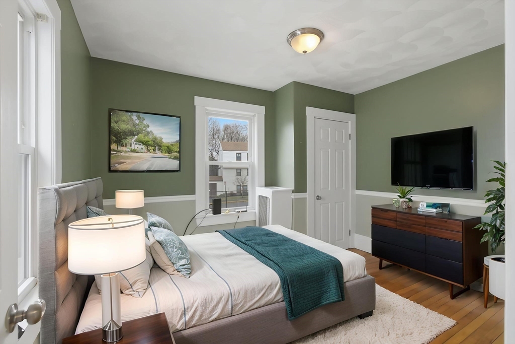 12 Riverside Court Saugus, MA 01906 - Photo 15 of 39 a bedroom with a bed and a flat screen tv
