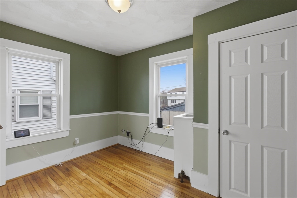 12 Riverside Court Saugus, MA 01906 - Photo 16 of 39 a view of a bedroom with wooden floor and a window