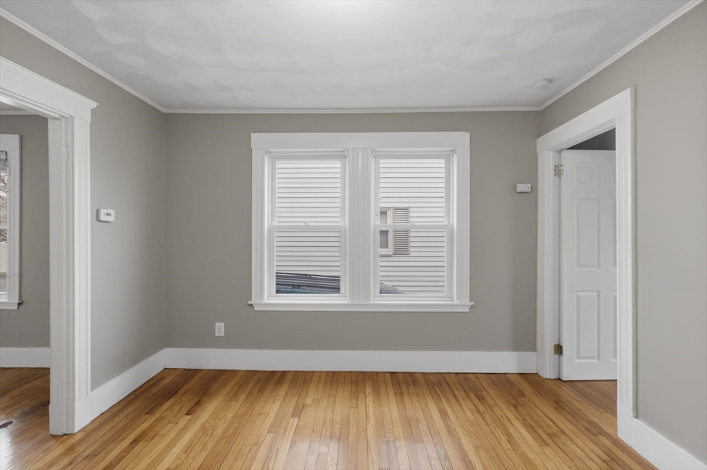 12 Riverside Court Saugus, MA 01906 - Photo 18 of 39 an empty room with wooden floor and windows
