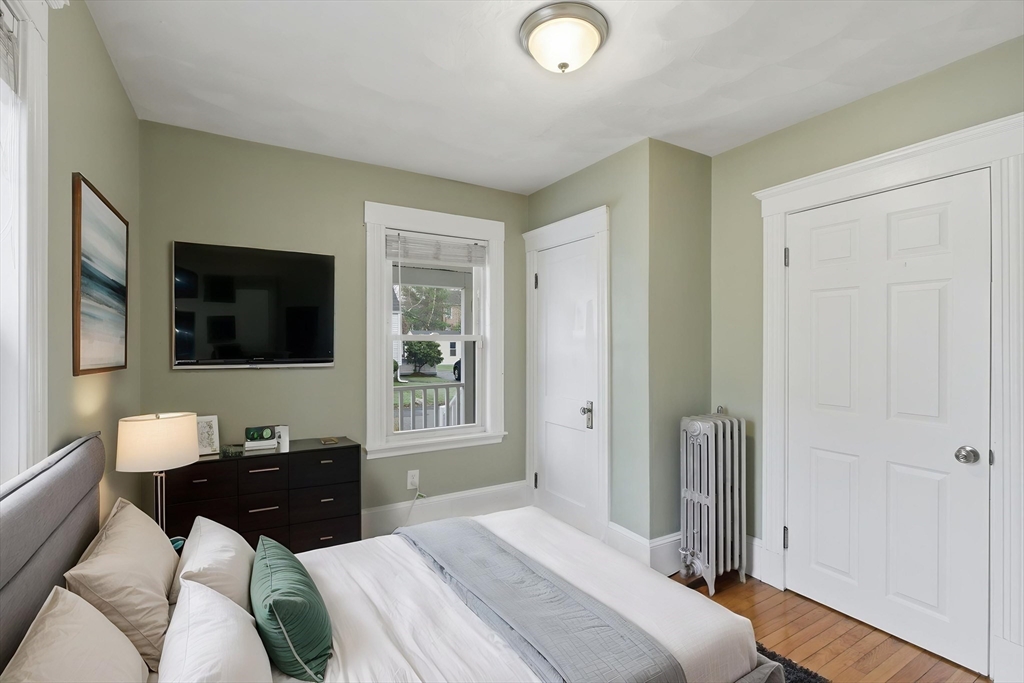 12 Riverside Court Saugus, MA 01906 - Photo 20 of 39 a bedroom with a bed and a flat screen tv