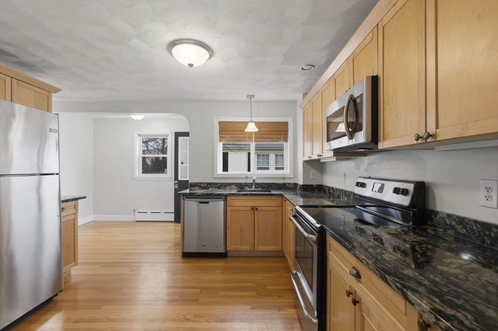 12 Riverside Court Saugus, MA 01906 - Photo 2 of 39 a kitchen with stainless steel appliances granite countertop a stove a sink and a refrigerator