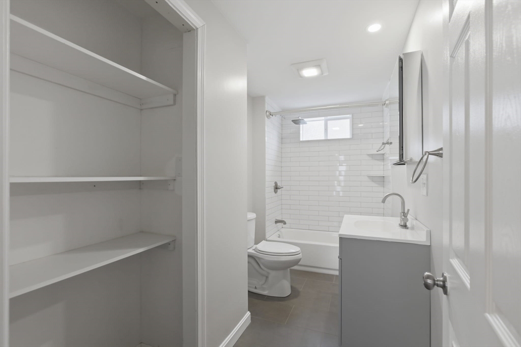 12 Riverside Court Saugus, MA 01906 - Photo 21 of 39 a bathroom with a toilet a sink and a large mirror
