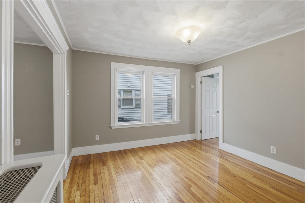 12 Riverside Court Saugus, MA 01906 - Photo 25 of 39 a view of an empty room with wooden floor and a window