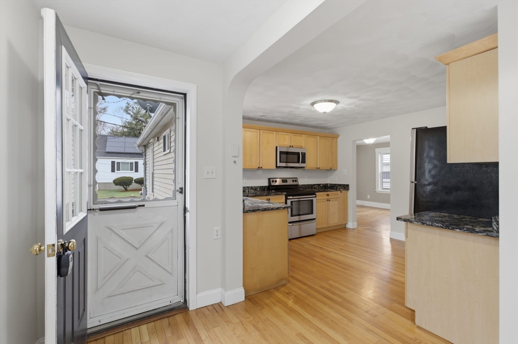 12 Riverside Court Saugus, MA 01906 - Photo 8 of 39 a kitchen with a refrigerator and a stove top oven