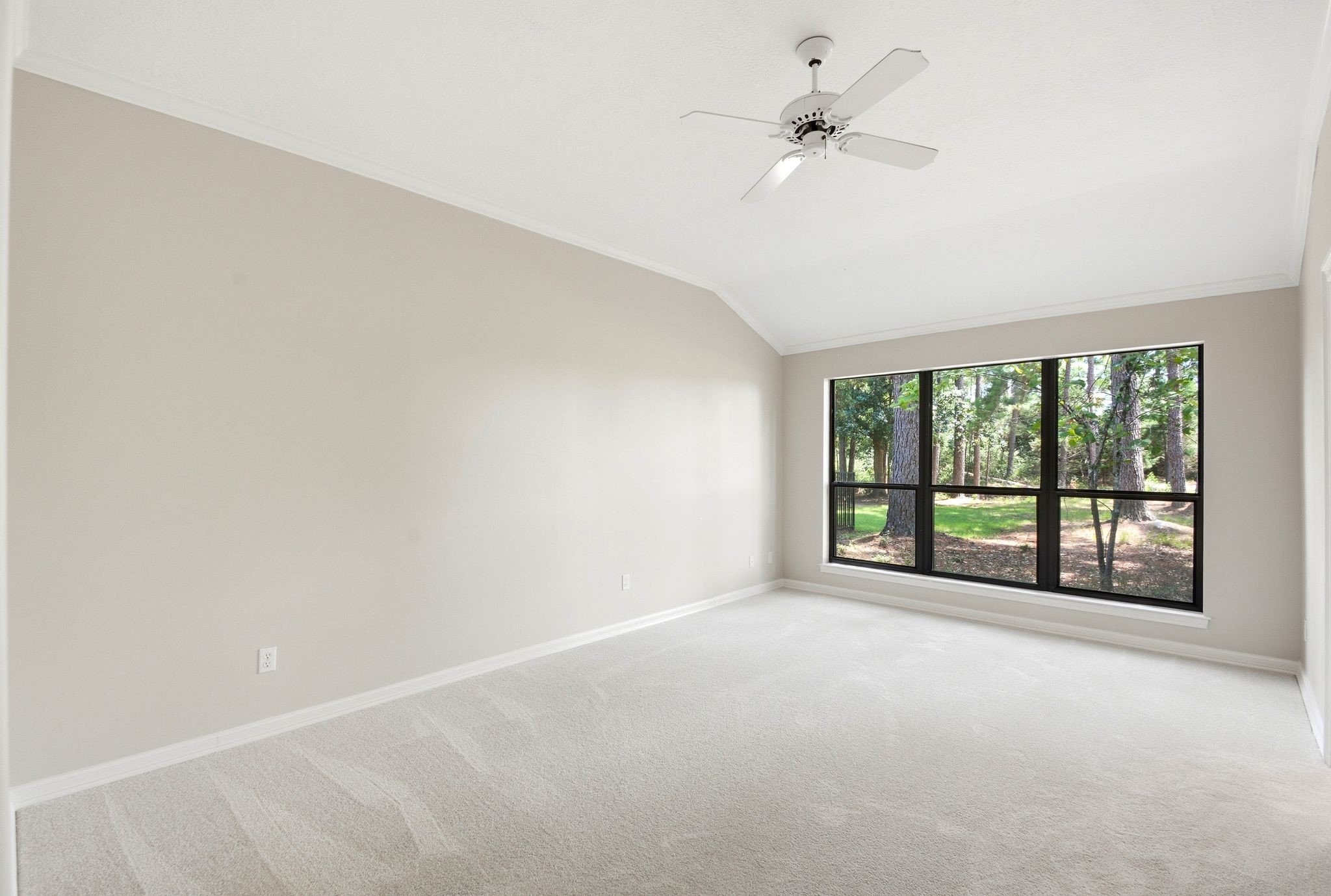 22509 Pebble Beach Way Point Blank, TX 77364 - Photo 17 of 30 Spacious primary bedroom with vaulted ceiling and new carpet