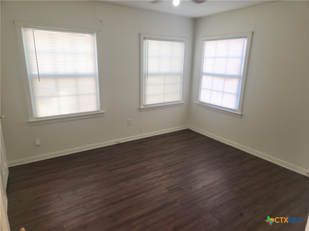 902 South 23rd Street Temple, TX 76504 - Photo 8 of 8 an empty room with wooden floor and windows
