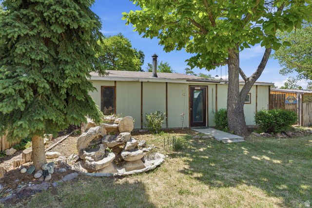 365 North Main Street Fillmore, UT 84631 - Photo 32 of 51 Manicured lawn with mature trees and a decorative rock water feature