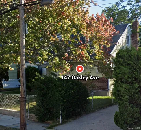 a view of a street sign under a large tree
