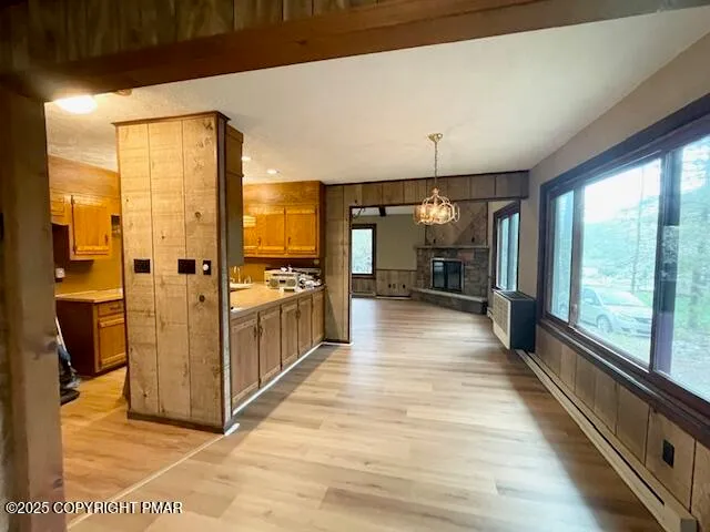 a view of a hallway with wooden floor and a living room