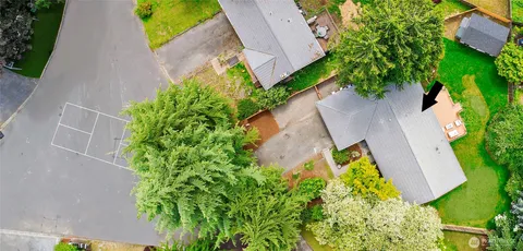 an aerial view of a house with swimming pool and garden
